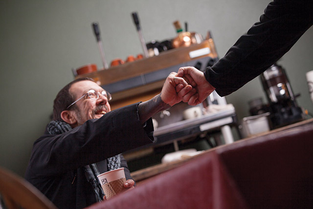 Love greets a friend at the monastery’s bookstore and cafe. 