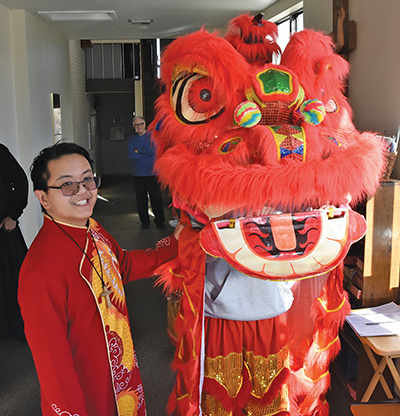  Pictured here is Brother Thomas Nguyen, G.H.M. with a dragon dancer during a Glenmary Lunar New Year celebration. 
