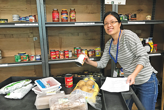 Sister Phuong Dong, R.S.M. helps out at a food pantry.