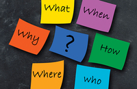 Post-it notes with questions on a chalkboard