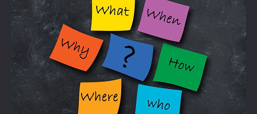 Post-it notes with questions on a chalkboard