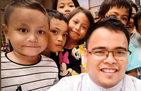 Brother Joel C. Añasco, S.C., with some of the low-income children his community serves in the Philippines.
